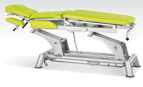 A yellow covered massage table, with steel legs.