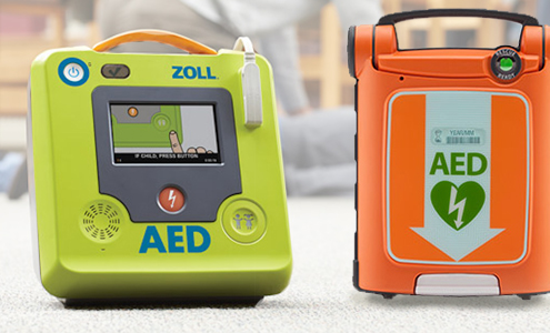 2 AED laying next to each other, one of them is orange, the other is green