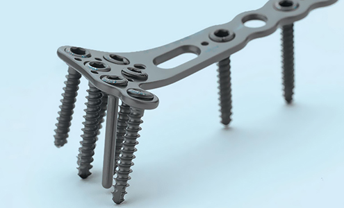 An orthopedical tool made of black steel with many screws