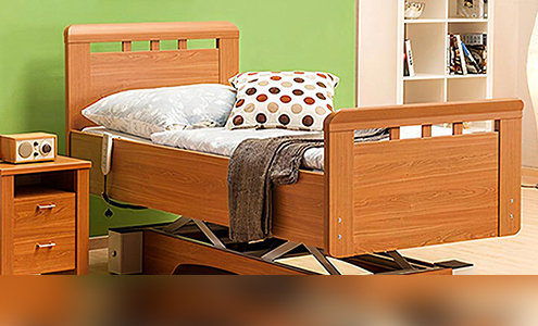 An electrical bed with wooden design and fully made bedding.